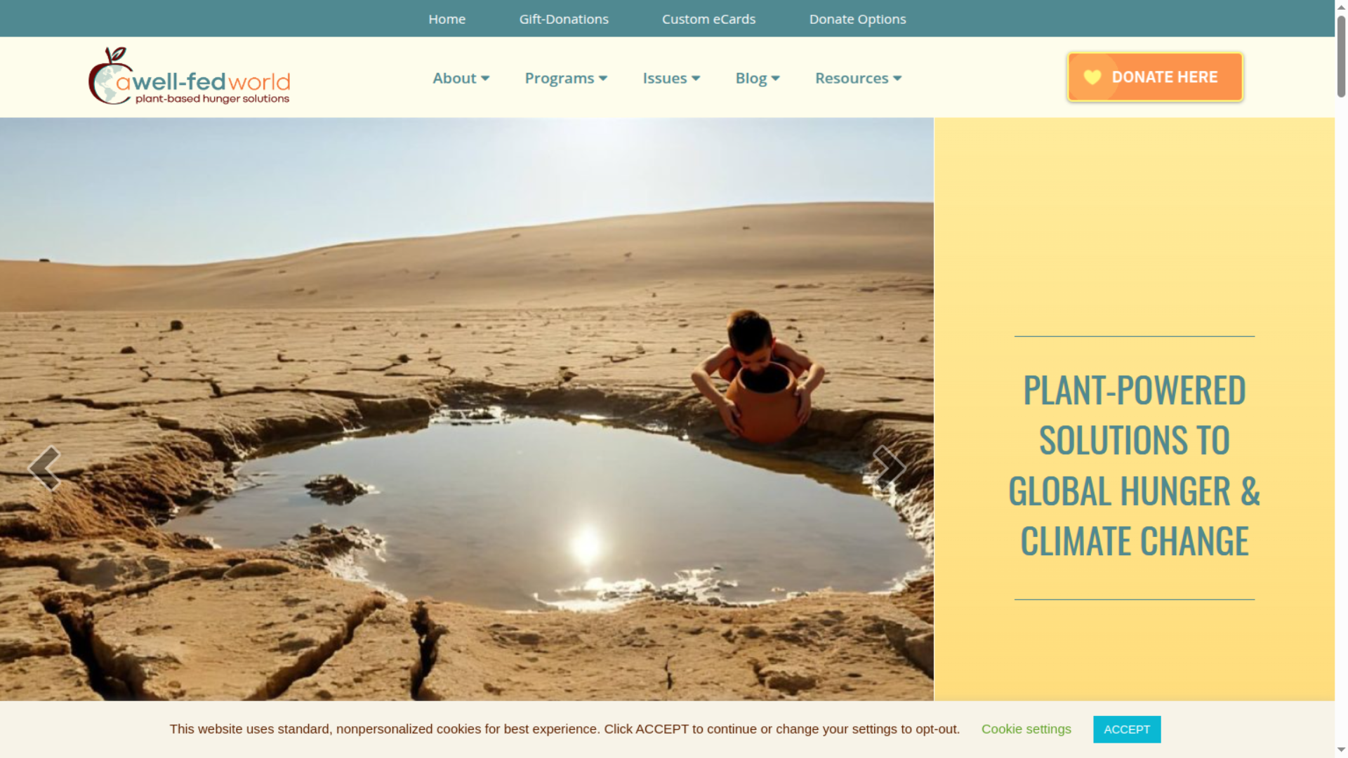 Well Fed World website banner showing assorted grains, lentils, and seeds arranged around a bowl of millet with heart shapes, alongside text "Plant powered solutions to global hunger and climate change "